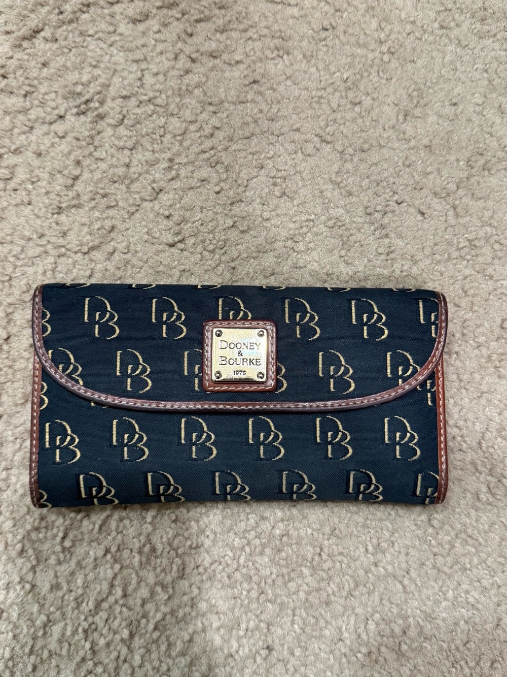 Dooney & Bourke Black Wallet with Brown Trim and Logo Plaque
